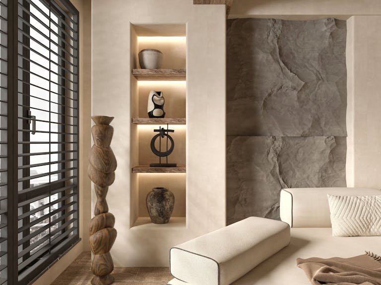 A living room with a white couch and a stone wall